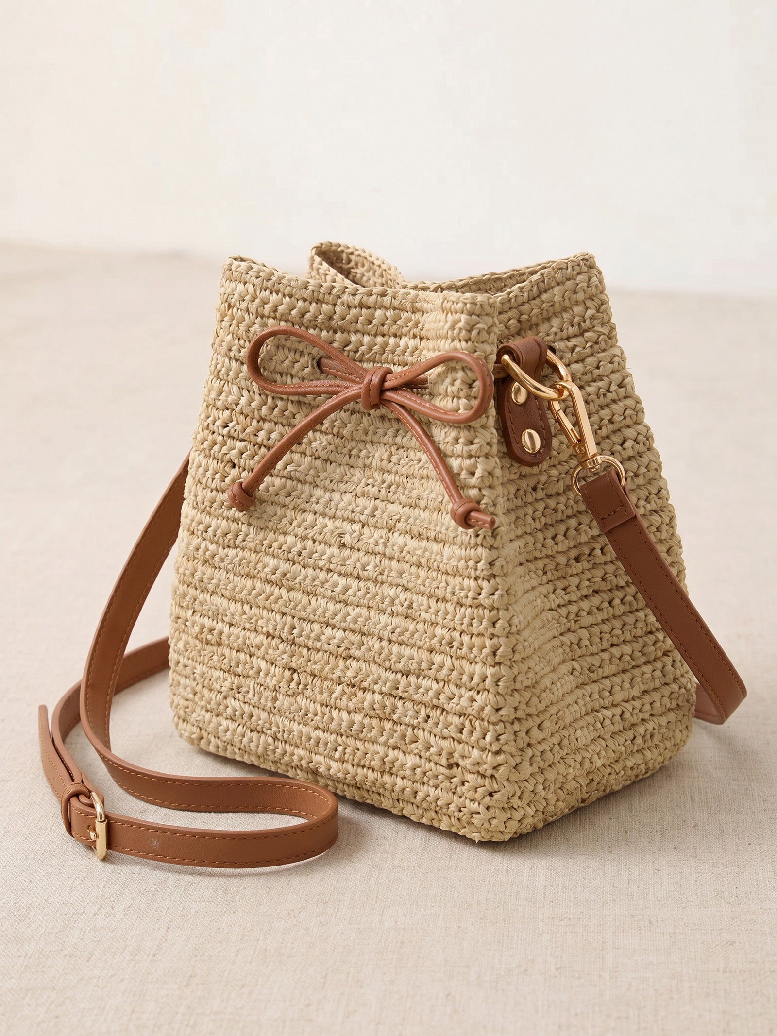 Mini Handwoven Raffia Drawstring Crossbody Bag by LINTICO