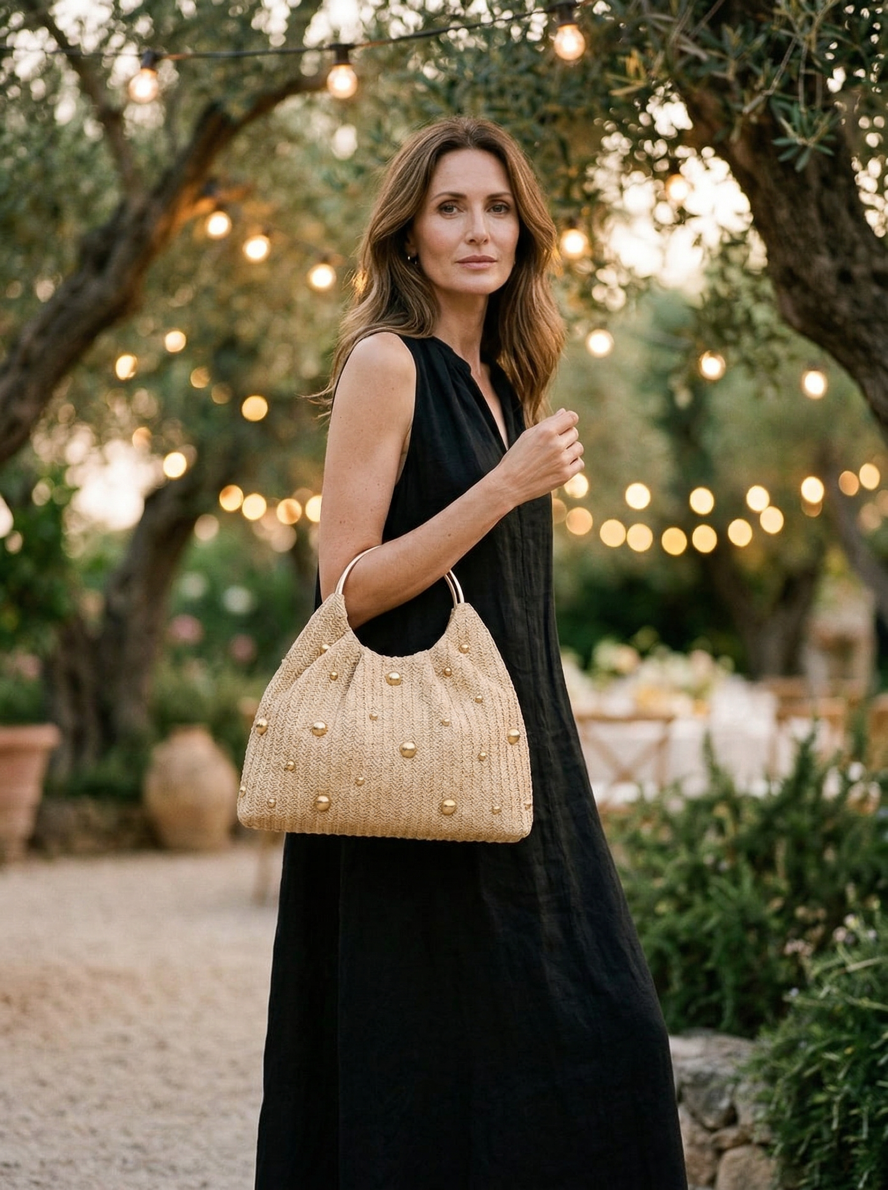 Artisanal Studded Handwoven Raffia Bag with Sculptural Gold Ring Handle by LINTICO
