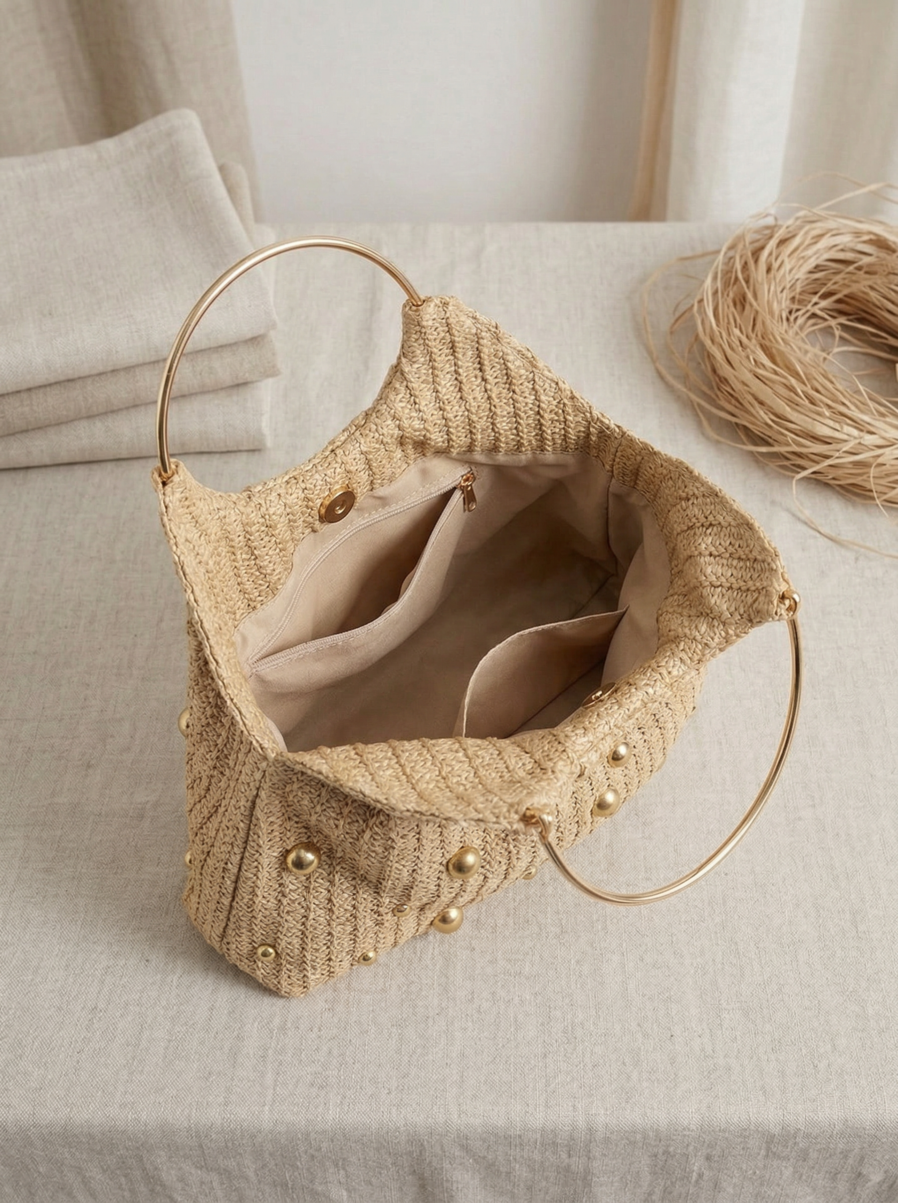 Artisanal Studded Handwoven Raffia Bag with Sculptural Gold Ring Handle by LINTICO